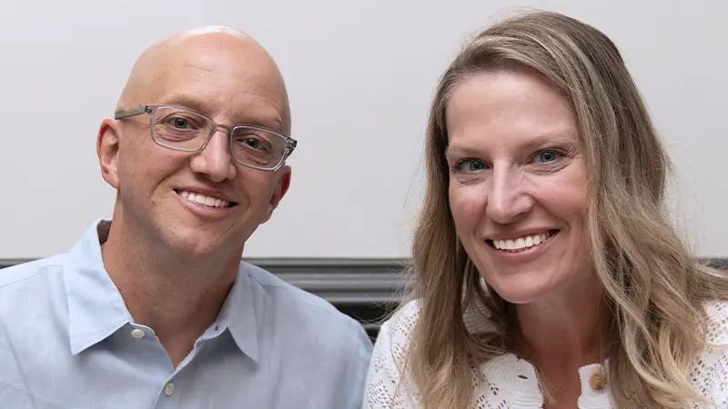 Man and woman together smiling at the camera, perfected smiles