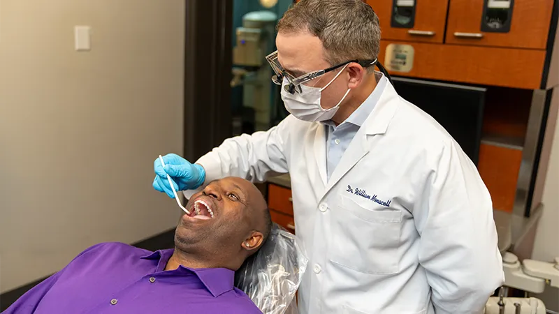 Dentist performing a periodontal examination