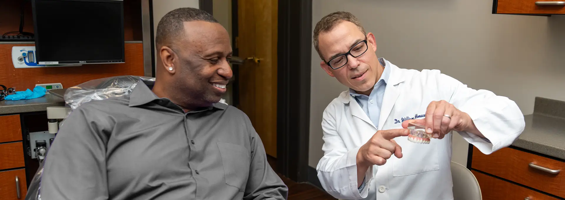 Doctor showing Implant Model to Patient