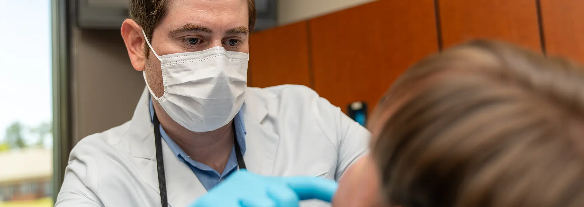 Doctor Closely Examining Patient