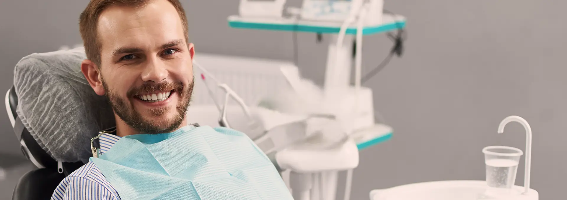Patient in Dental Chair Smiling in Camera