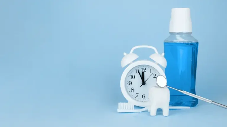 Alarm clock, tooth model, mouthwash, dentist mirror still life