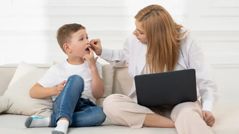 Mom on couch at home with son checking his mouth pain